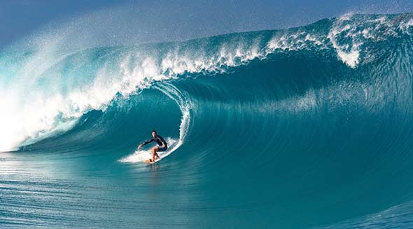 Surfer on a big wave in Tahiti